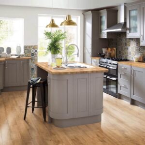 B8 Farmhouse-style kitchen with gray island and wooden stools.