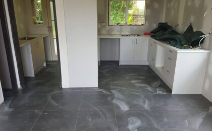 Kitchen in progress, recently tiled, walls plastered.