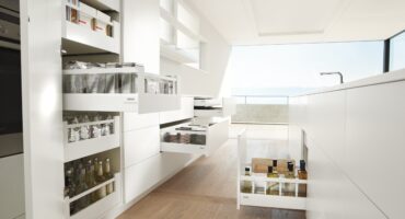 Modern kitchen with pantry pull-out shelves open.